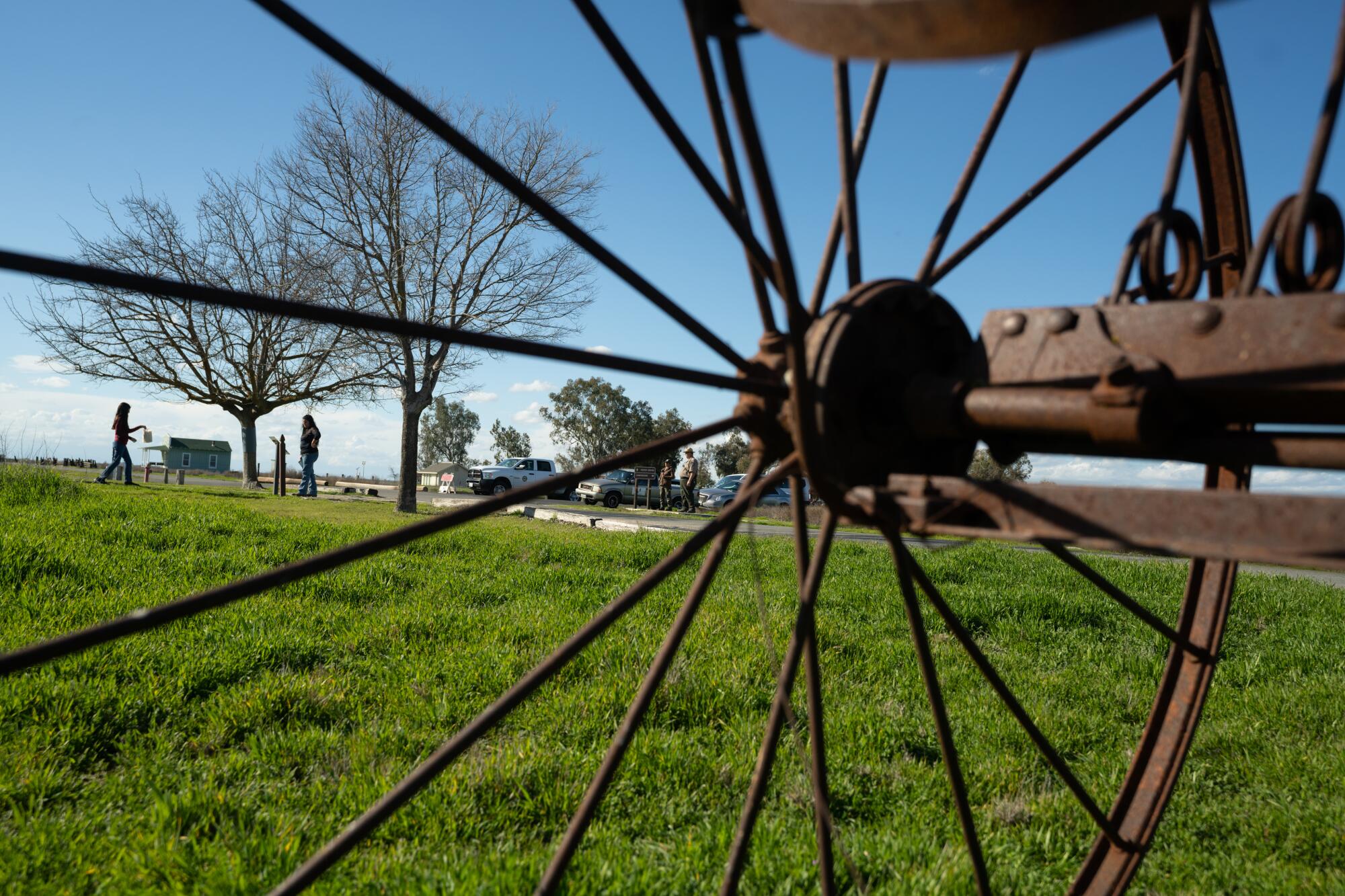 A rusted piece of farm equipment frames visitors to Colonel Allensworth State Historic Park.