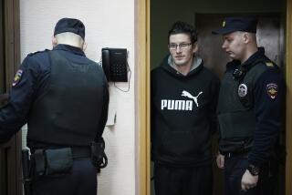 U.S. citizen Robert Woodland Romanov, center, is escorted into a glass cage prior to a court session on drug-related charges in Moscow, Russia, on Thursday, April 25, 2024. The U.S. citizen arrested on drug charges in Moscow amid soaring Russia-U.S. tensions has appeared in court. Robert Woodland Romanov is facing charges of trafficking large amounts of illegal drugs as part of an organized group — a criminal offense punishable by up to 20 years in prison. (AP Photo/Alexander Zemlianichenko)