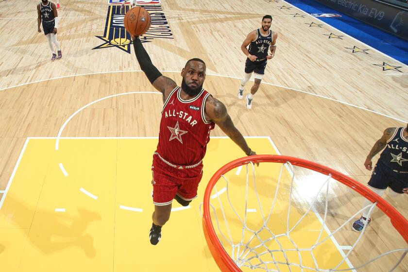 Lakers star LeBron James dunks during the first half of the NBA All-Star Game in Indianapolis on Sunday.