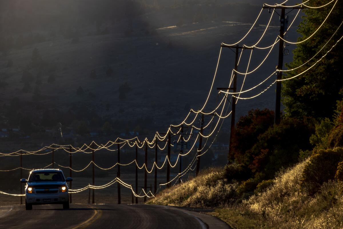 Power lines shine in the sunlight along Richmond Road in Susanville, Calif.