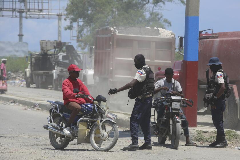 Police check motorcyclists near the airport in Port-au-Prince, Haiti, Friday, May 24, 2024. (AP Photo/Odelyn Joseph)