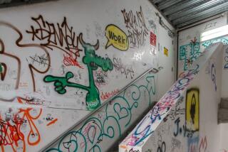 white walls in a stairwell covered in graffiti and drawings 