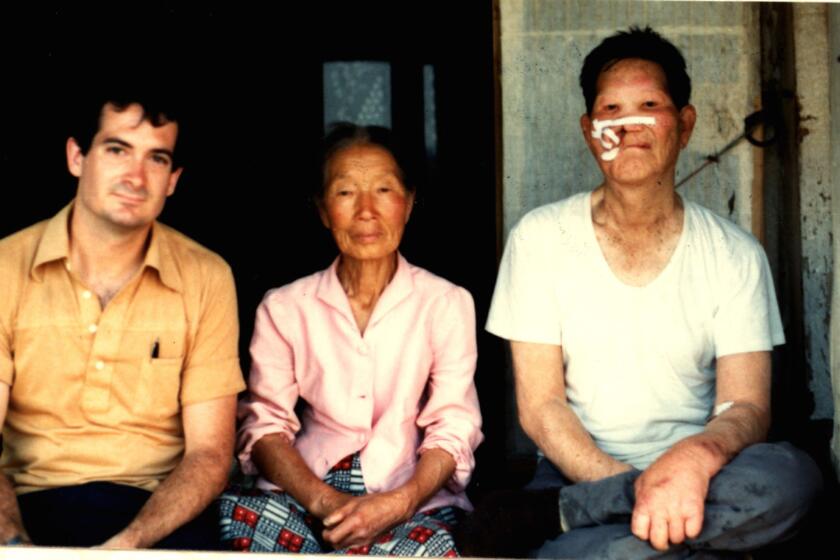 Paul Courtright with two residents of HoHae village, where he worked in South Korea