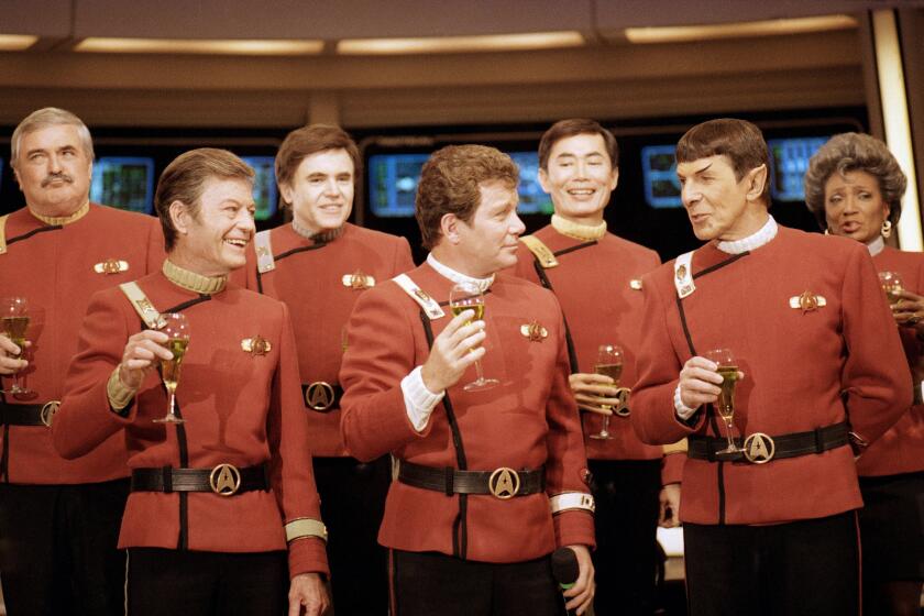 FILE - Members of the "Star Trek" crew, from left, James Doohan, DeForest Kelley, Walter Koenig, William Shatner, George Takei, Leonard Nimoy and Nichelle Nichols, toast the newest "Star Trek" film during a news conference at Paramount Studios in Los Angeles, Dec. 28, 1988. (AP Photo/Bob Galbraith, File)