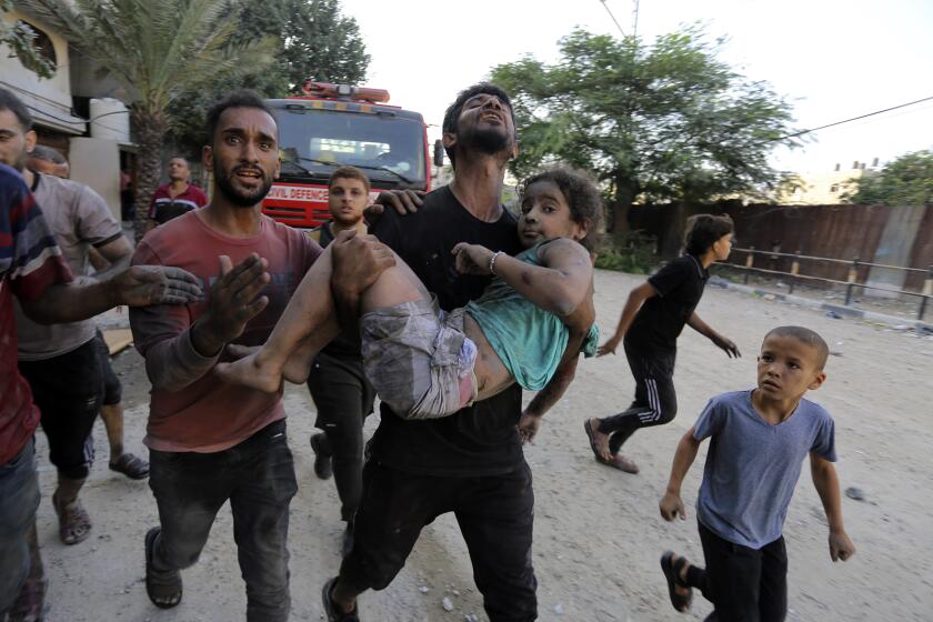 Palestinians carry a wounded girl after being rescued from under the rubble of buildings that were destroyed by Israeli airstrikes in Jabaliya refugee camp, northern Gaza Strip, Wednesday, Nov. 1, 2023. In just 25 days of war, more than 3,600 Palestinian children have been killed in Gaza, according to Gaza's Hamas-run Health Ministry. The advocacy group Save The Children says more children were killed in Gaza in October 2023 than in all conflict zones around the world combined in 2022. (AP Photo/Abed Khaled)