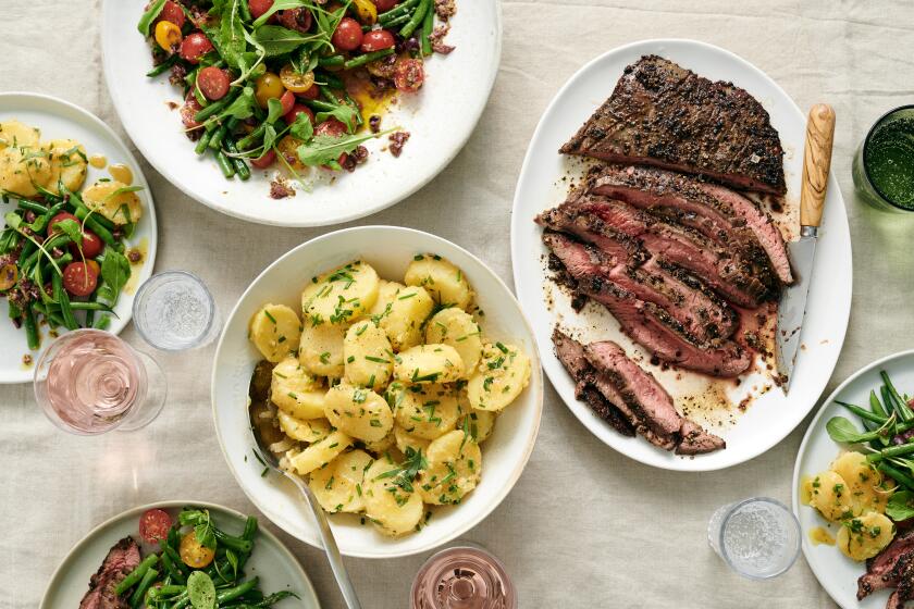 Clockwise from top: cherry tomato and green bean salad; pepper-crusted flank steak and French potato salad.
