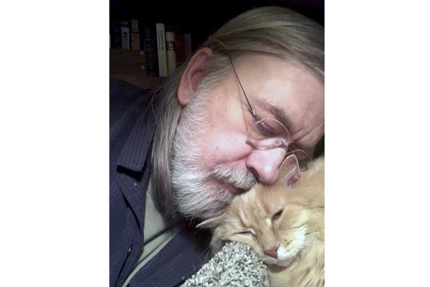 This undated self portrait made available by Little Brown publisher, shows author Caleb Carr and his cat Masha at his home in Cherry Plain, NY. Carr died of cancer Thursday, May 23, 2024, according to his publisher, Little, Brown and Company. (Caleb Carr/Little Brown via AP)