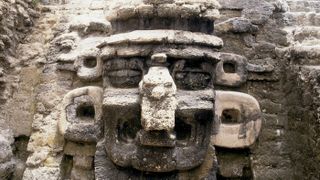 A mask of the rain god Chac decorates the facade of a pyramid at North Acropolis, in Mayan ruins, located in Tikal, Guatemala.
