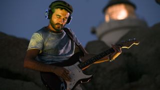 Italian guitarist Perry Frank , with his ambient guitar session, plays in the splendid setting of the Capo Testa lighthouse in Santa Teresa di Gallura for the first evening of the Silent Sardinia Festival, a concert completely with headphones on July 27, 2021 in Santa Teresa di Gallura, Italy. 