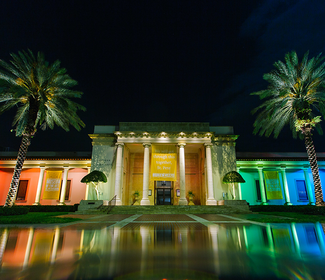 The Museum of Fine Arts lit up in rainbow colors at night to celebrate St Pete Pride