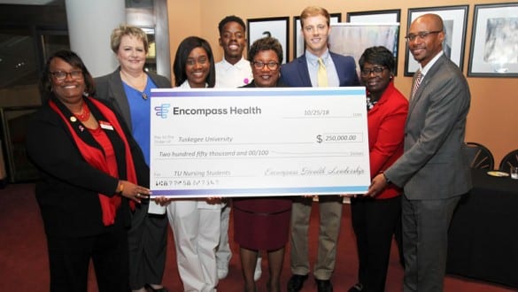 Group shot presentation of check form Encompass Health to Tuskegee University