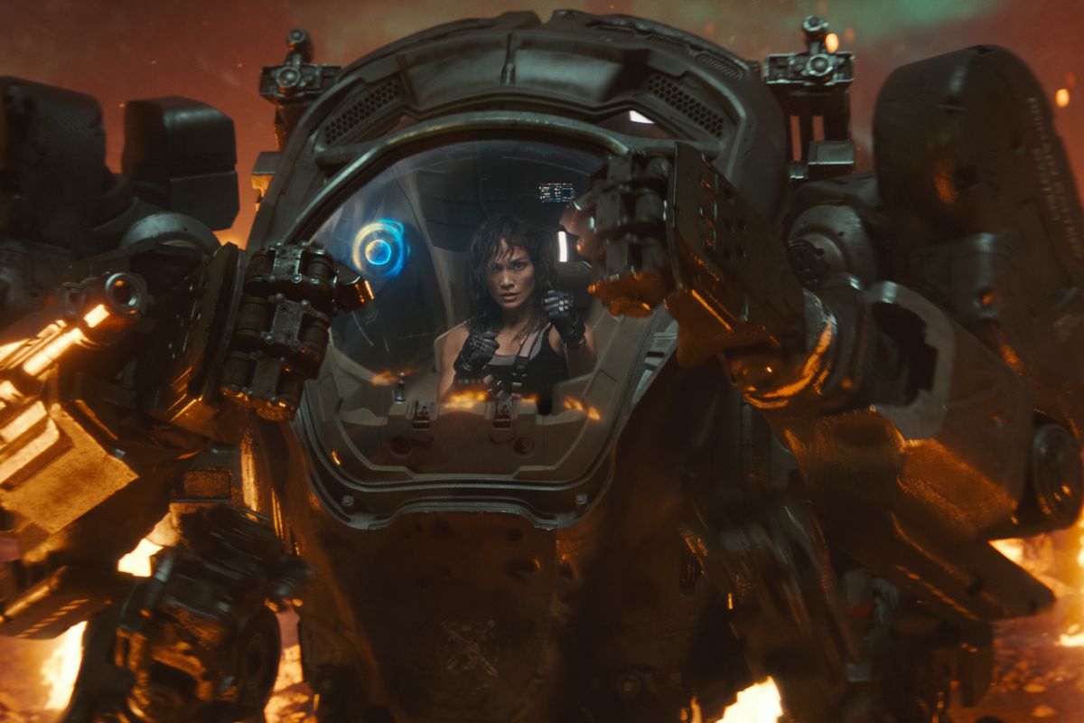 Jennifer Lopez as Atlas holding up her robo arms in a mech suit preparing for a fight