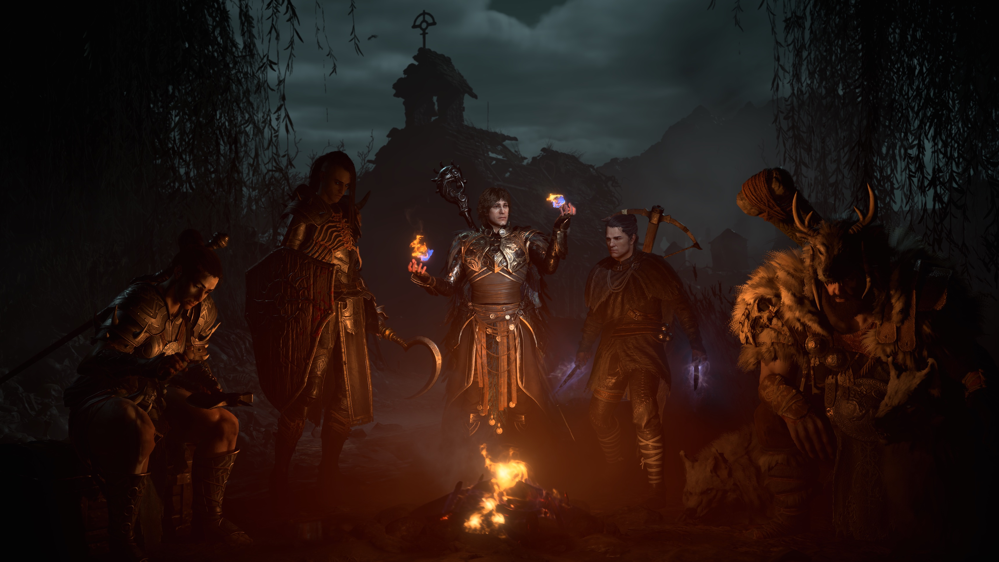 Character creator in Diablo 4 / IV. All of the characters, barbarian, necromancer, sorcerer, rogue, and druid, sat in front of a campfire at night.