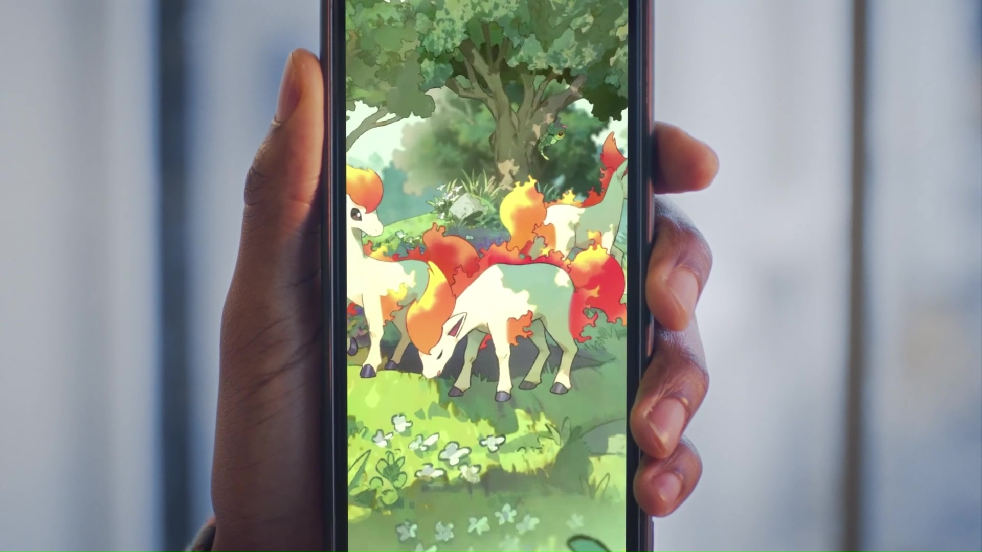 A closeup of a phone showing card art of Ponyta zoomed in, in Pokemon Trading Card Game Pocket.