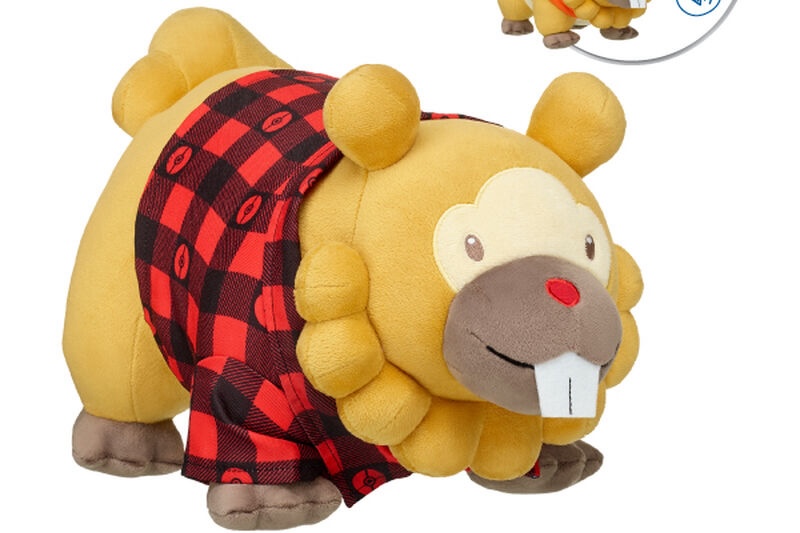 A product photo of a plush Bidoof pokémon from Build-A-Bear, wearing a truly adorable black and red plaid shirt with pokéball details. 