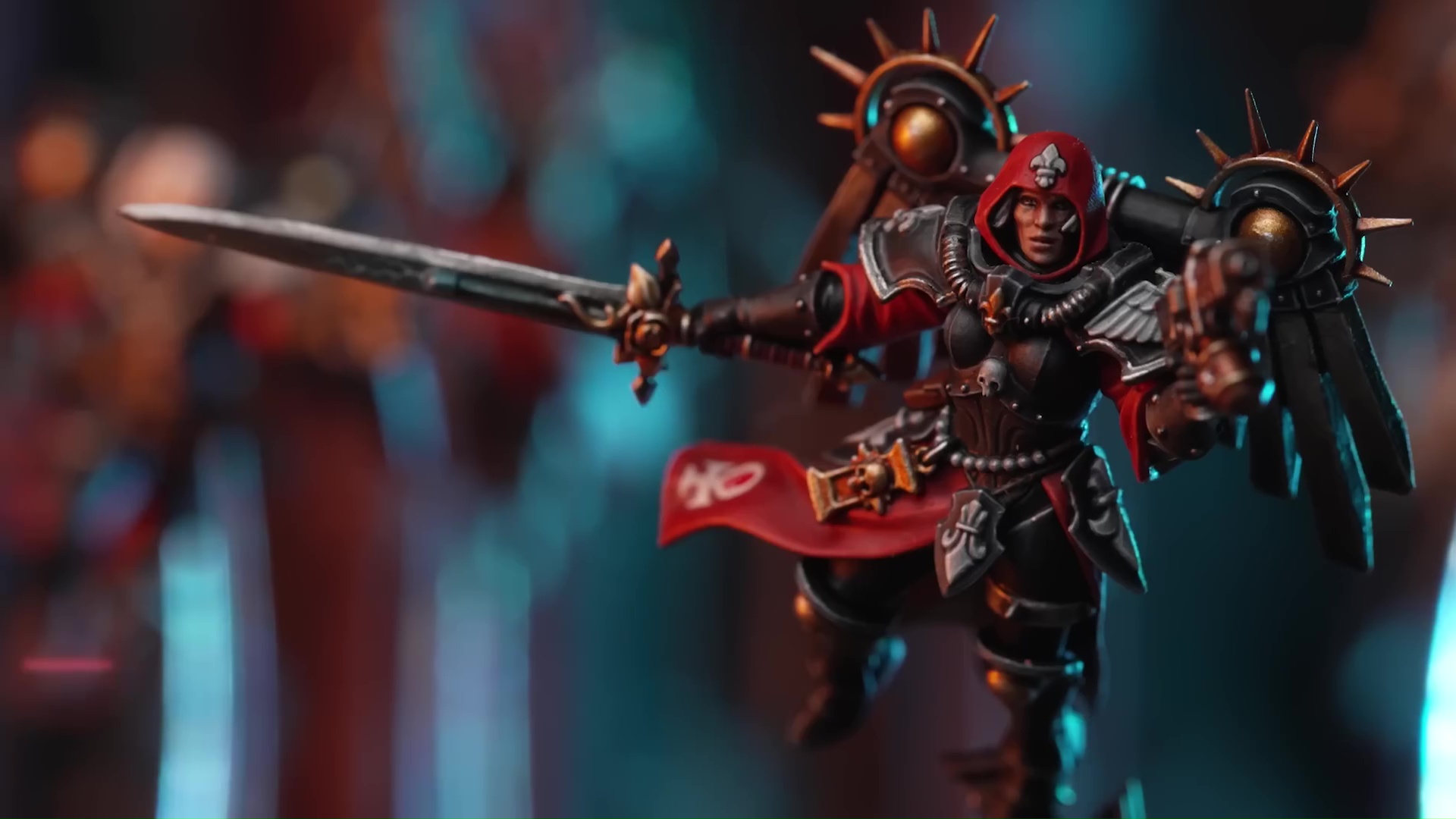 An Adepta Sororitas in red and black livery wearing a jump back and wielding a power sword.