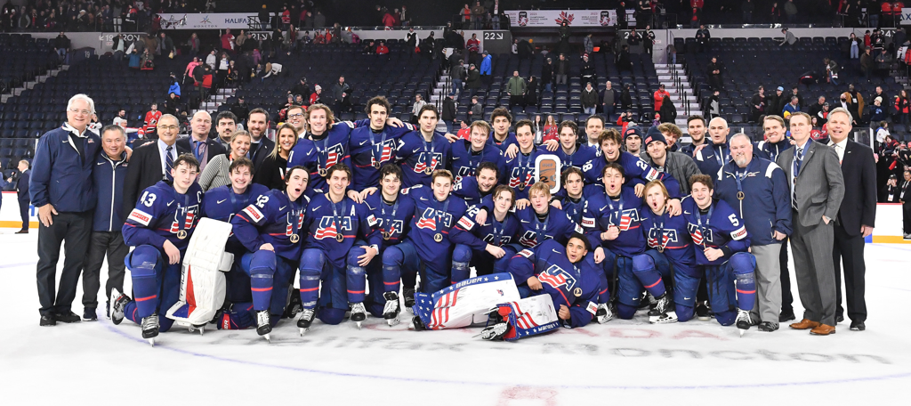 Team USA celebrates their bronze medal win over Sweden during the 2023 IIHF World Junior Championship.