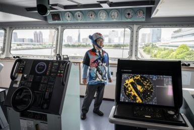 In whale-motif jacket, shirt and tie plus a whale-shaped hat, Hideki Tokoro shows off Japan's new whaling 'mothership'