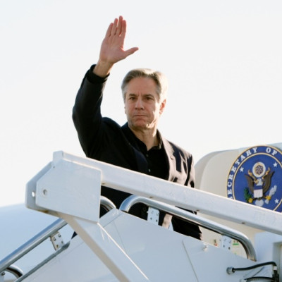 US Secretary of State Antony Blinken waves as he boards his plane at Joint Base Andrews on his way to Beijing