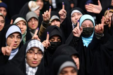 Iranian women voters showing their ink-stained fingers in a file picture from February 28, 2024