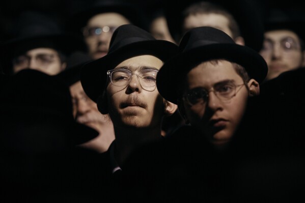 Chabad-Lubavitch Orthodox Jews listen during a prayer vigil held in solidarity with Israel on Monday, Oct. 9, 2023, in New York. (AP Photo/Andres Kudacki, File)