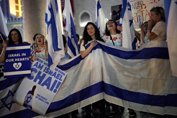 People hold flags and banners during a rally in support of Israel, Sunday, Oct. 8, 2023, in Las Vegas. (AP Photo/John Locher, File)