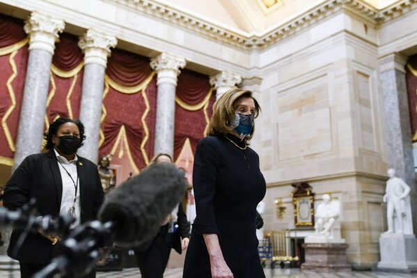 Speaker of the House Nancy Pelosi of Calif., returns to her leadership office from the House chamber at the Capitol in Washington, Wednesday, Jan. 13, 2021, as the House of Representatives pursues an article of impeachment against President Donald Trump for his role in inciting an angry mob to storm the Capitol last week. (AP Photo/Susan Walsh)