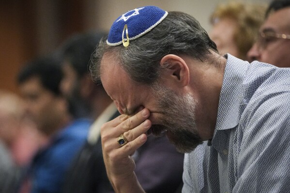 A man wipes away tears during an event organized to support Israel in its fighting with Hamas militants on Monday, Oct. 9, 2023, at Congregation Beth Yeshurun in Houston. ( Jon Shapley/Houston Chronicle via AP, File)