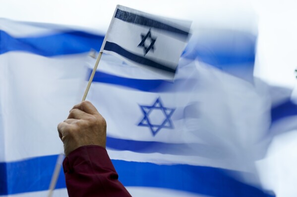 A demonstrator waves the flag of Israel during a rally Monday, Oct. 9, 2023, in Bellevue, Wash. (AP Photo/Lindsey Wasson, File)