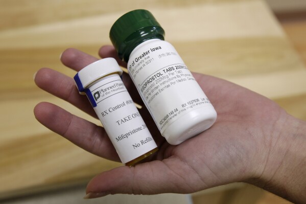 FILE - Bottles of abortion pills mifepristone, left, and misoprostol, right, are shown, Sept. 22, 2010, at a clinic in Des Moines, Iowa. Thousands of women stocked up on abortion pills just in case they needed them, according to new research published Tuesday, Jan. 2, 2024, in JAMA Internal Medicine, with demand peaking in the past couple years at times when it looked like the medications might become harder to get. (AP Photo/Charlie Neibergall, File)