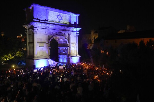 People attend a torchlit during a rally in support of Israel, at the Emperor Tito's Arch in Rome, Tuesday, Oct. 10, 2023. (AP Photo/Andrew Medichini, File)