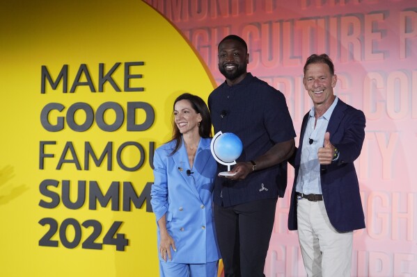NBA Hall of Famer Dwyane Wade, center, poses with Carolina Garcia Jayaram, left, CEO of the Elevate Prize Foundation, and Joseph Deitch, right, founder of the foundation, after having received the Elevate Prize Catalyst Award, Thursday, May 23, 2024, at the Make Good Famous Summit in Miami Beach, Fla. Wade has launched Translatable, a nonprofit online community dedicated to supporting transgender youth. (AP Photo/Wilfredo Lee)