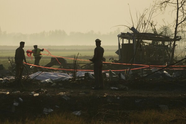 Thai police officers work the scene of an explosion at a firework factory in Suphan Buri province, Thailand, Thursday, Jan. 18, 2024. The blast in central Thailand killed multiple people on Wednesday, according to provincial officials. The devastation at the scene has made the death toll uncertain. (AP Photo/Sakchai Lalit)