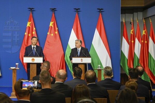 FILE - Chinese President Xi Jinping, left, listens during his joint press conference with Hungarian Prime Minister Viktor Orban following their talks at the PM's office, the former Carmelite Monastery, in Budapest, Hungary, Thursday, May 9 2024. Most countries in the European Union are making efforts to “de-risk” their economies from perceived threats posed by China. But Hungary and Serbia have gone in the other direction. They are courting major Chinese investments in the belief that the world’s second-largest economy is essential for Europe’s future. (Szilard Koszticsak/MTI via AP, File)