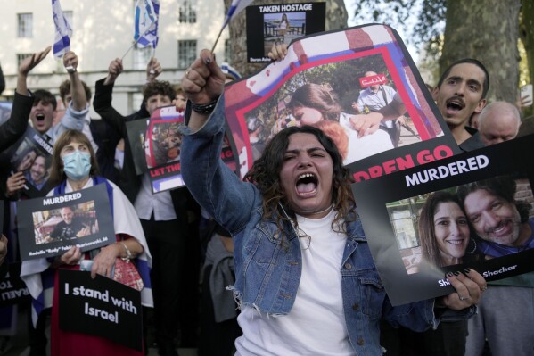 Protesters show photos and placards during the 'Jewish Community Vigil' for Israel in London, Monday, Oct. 9, 2023, two days after Hamas fighters launched a multi-front attack on Israel. (AP Photo/Kin Cheung, File)
