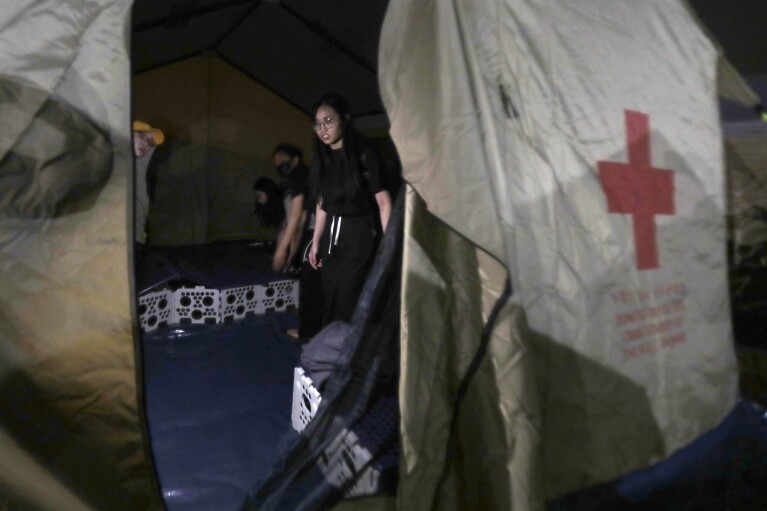 People evacuated from their homes are accommodated in the tent area of the shelter after the main earthquake in Hualien City, eastern Taiwan, Thursday earlier morning, April 4, 2024. The strongest earthquake in a quarter-century has rocked Taiwan during the morning rush hour. (AP Photo/Chiang Ying-ying)