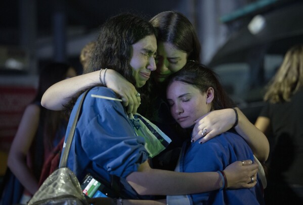 People cry and hug during a demonstration in support of Israel in Buenos Aires, on Monday, Oct. 9, 2023, after Hamas militants surprised Israel with a deadly attack on Saturday that breached its fortified borders. (AP Photo/Victor R. Caivano, File)
