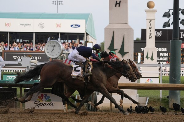 Sierra Leone with jockey Tyler Gaffalione (2), Forever Young with jockey Ryusei Sakai and Mystik Dan with jockey Brian Hernandez Jr., cross the finish line at Churchill Downs during the 150th running of the Kentucky Derby horse race, Saturday, May 4, 2024, in Louisville, Ky. (AP Photo/Kiichiro Sato)