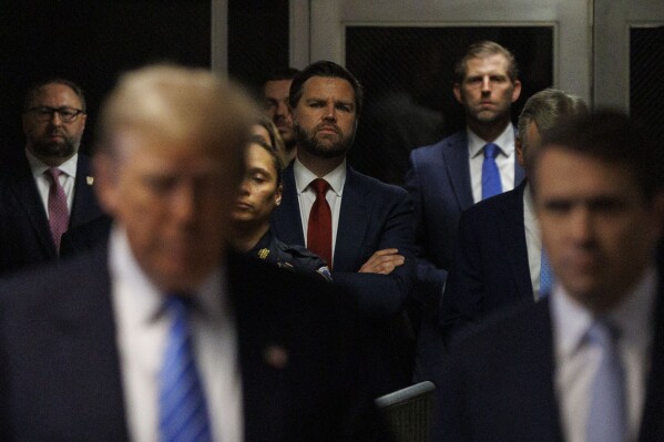 American author and politician J. D. Vance (C) watches as former President Donald Trump speaks to reporters with his lawyer Todd Blanche at Manhattan criminal court, Monday, May 13, 2024, in New York. (Sarah Yenesel/Pool Photo via AP)