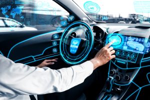 Man in the driver seat interacting with virtual screen inside the car.