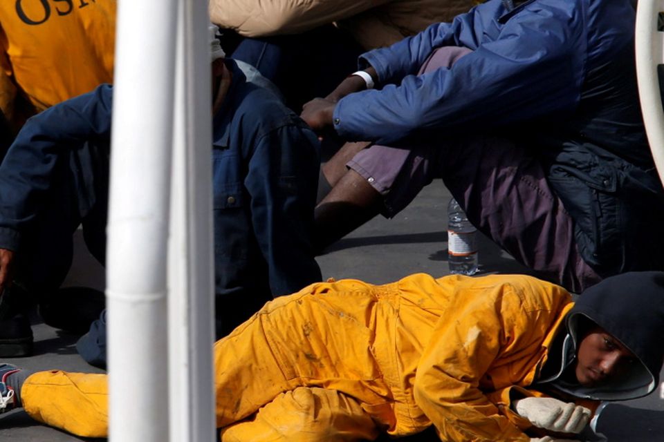 Surviving immigrants lie on the deck of Italian coastguard ship Bruno Gregoretti in Senglea, in Valletta's Grand Harbour REUTERS/Darrin Zammit Lupi