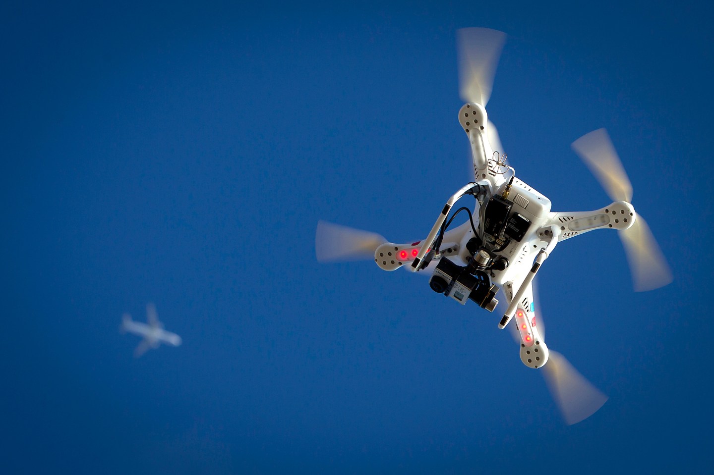 Airplane flies over a drone during the Polar Bear Plunge on Coney Island in the Brooklyn borough of New York