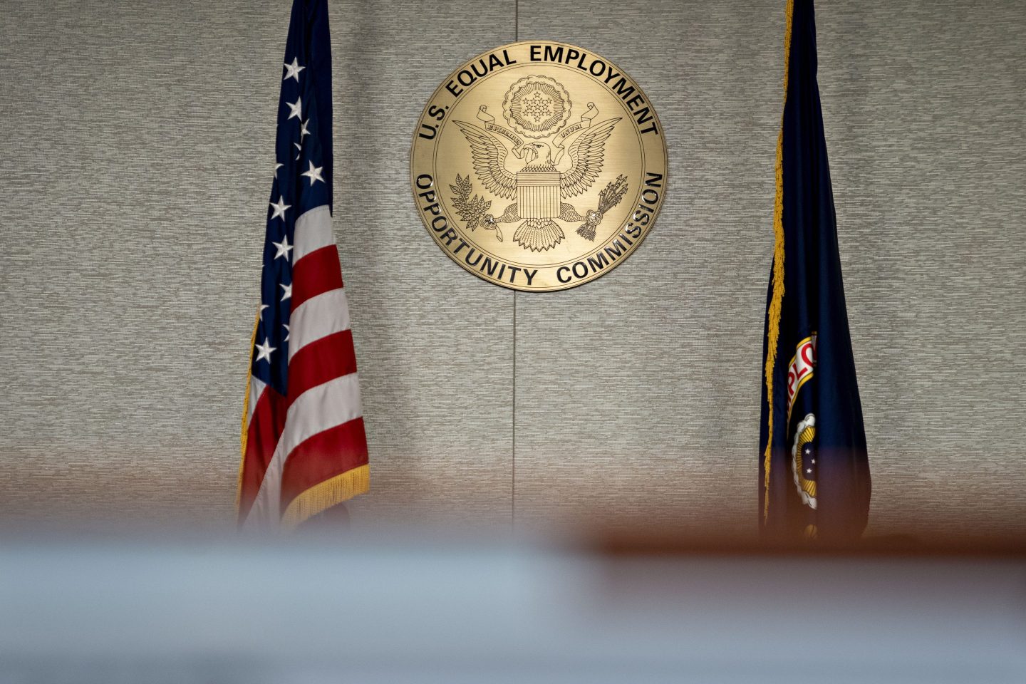 The Equal Employment Opportunity Commission (EEOC) seal hangs inside a hearing room at the headquarters in Washington, D.C., U.S., on Tuesday, Feb. 18, 2020. The Trump administration wants to cut fiscal year 2021 spending on the Labor Department, National Labor Relations Board, and EEOC, reviving previous belt-tightening bids that have not been approved by Congress. Photographer: Andrew Harrer/Bloomberg via Getty Images