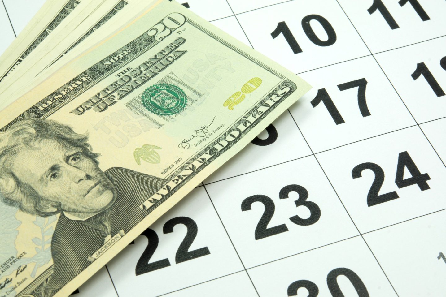 Dollar bills on a calendar