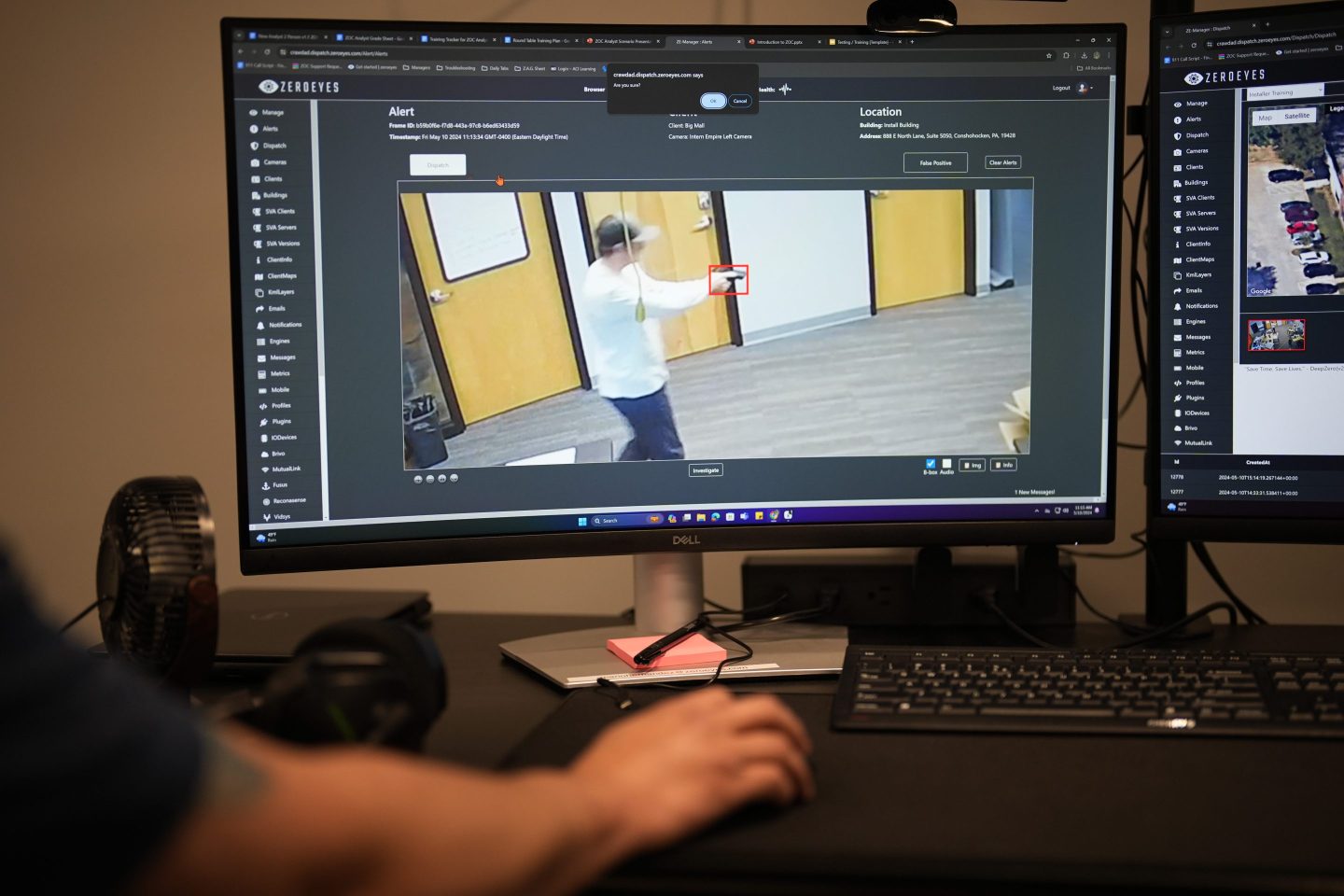 computer screen shows man holding gun