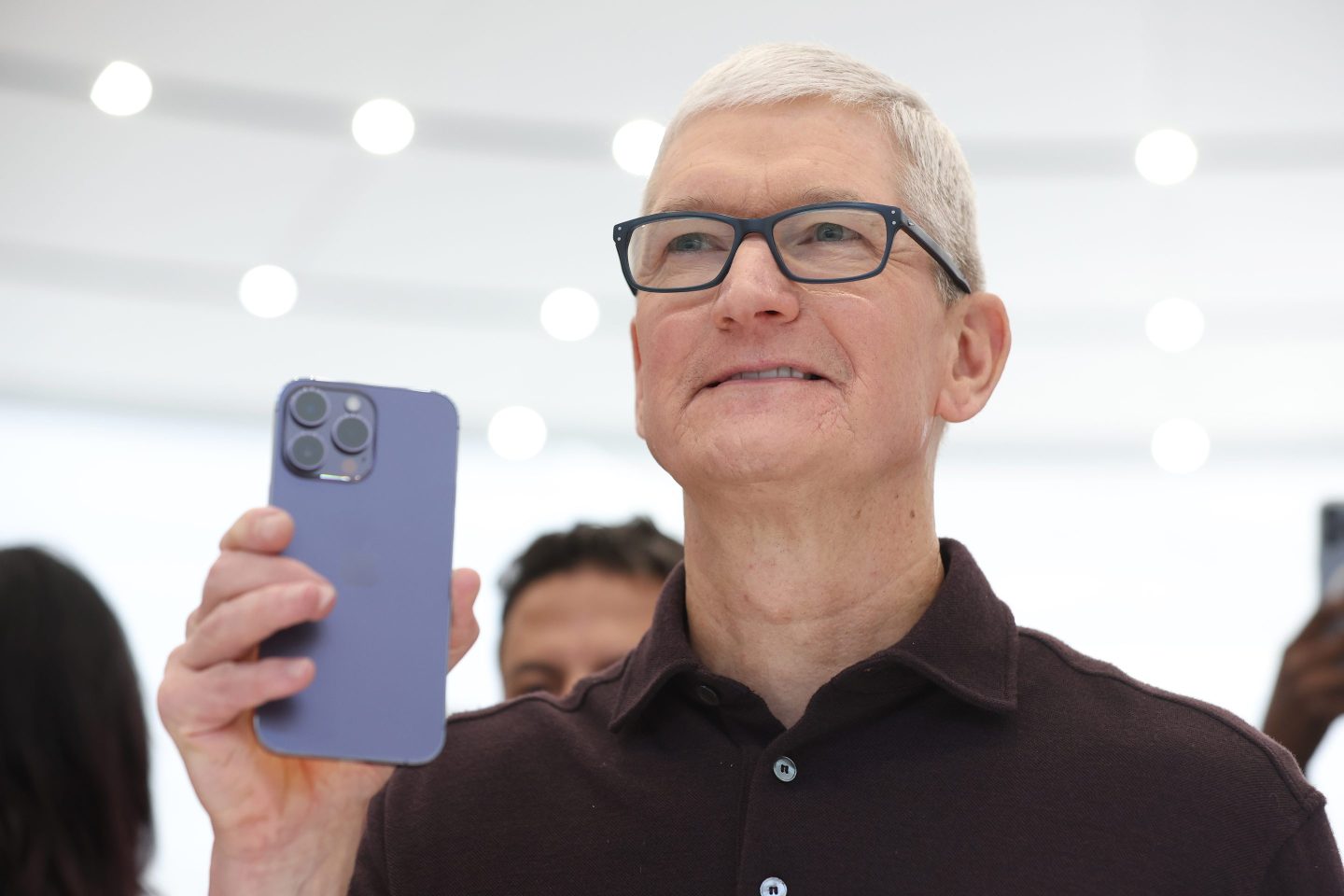Apple CEO Tim Cook holds iPhone