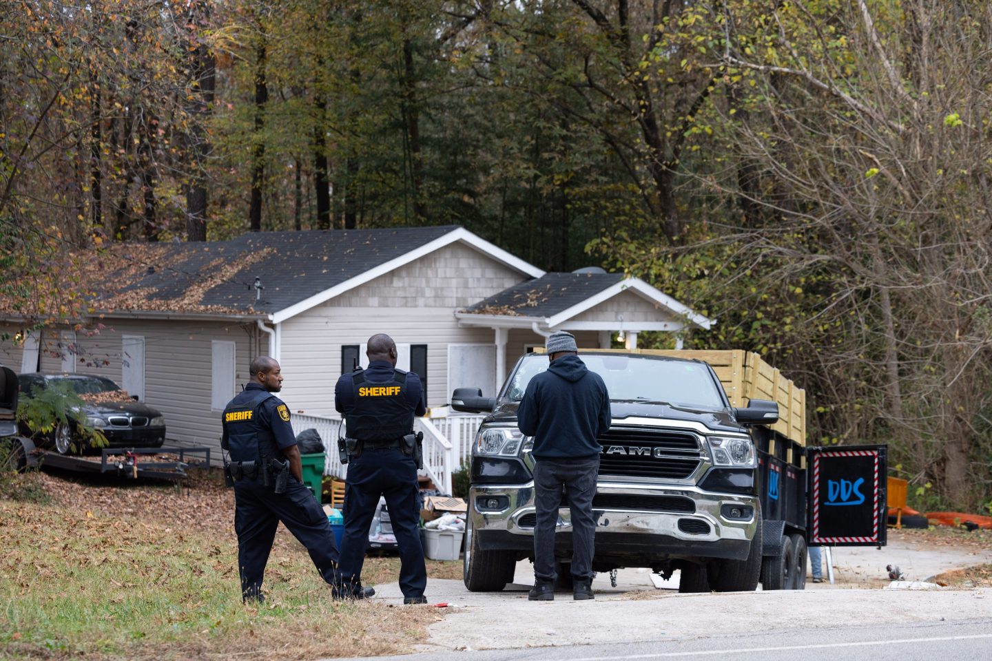 Police supervise the removal of items that belong to squatters from the premises of a rental property in Ellenwood, Georgia, US, on Friday, Nov. 17, 2023. An estimated 1,200 homes are illegally occupied in the Atlanta metro area, an epicenter for institutional investors. Photographer: Elijah Nouvelage/Bloomberg via Getty Images