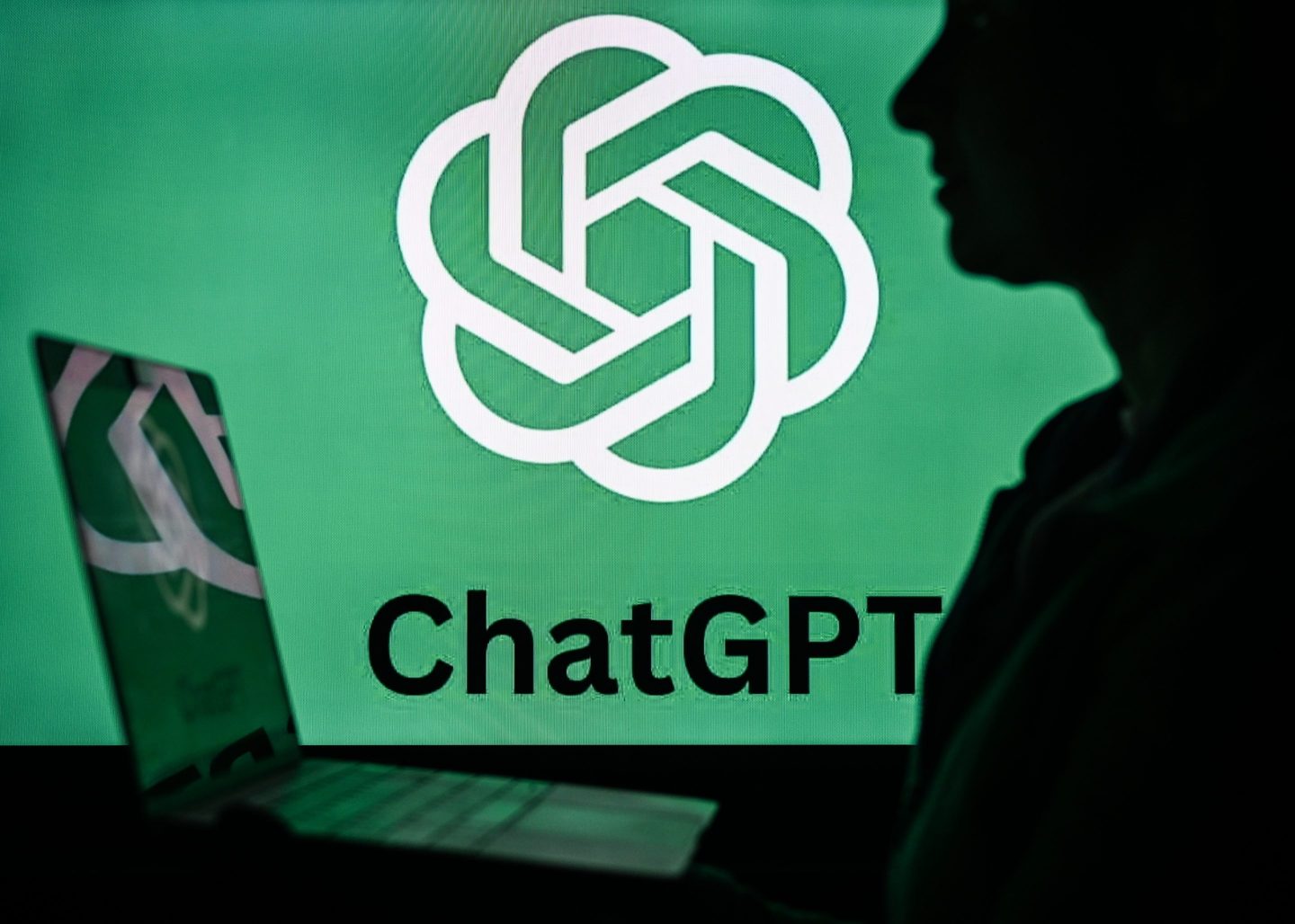 An image of a woman holding a laptop in front of a ChatGPT logo
