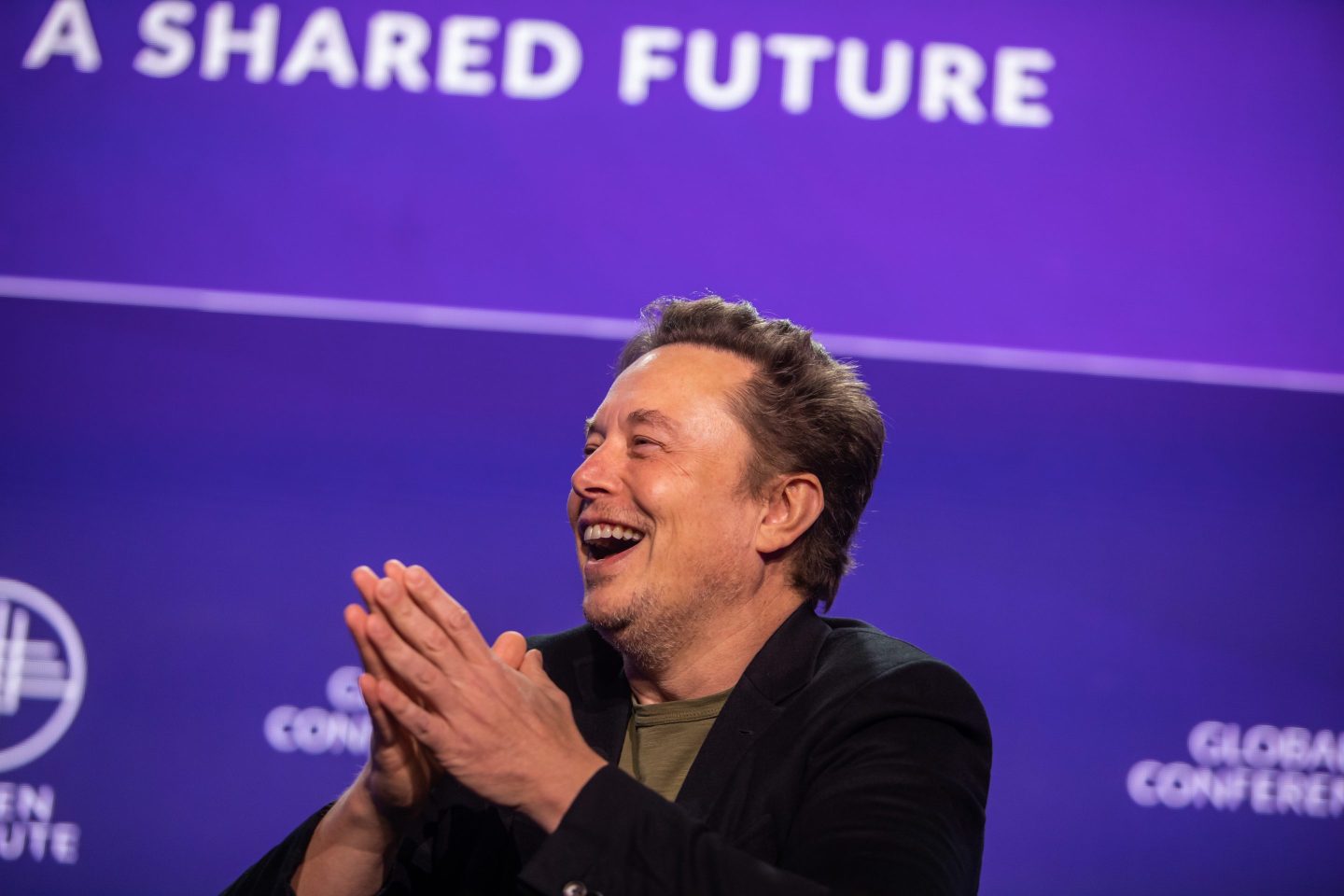 Elon Musk claps hands