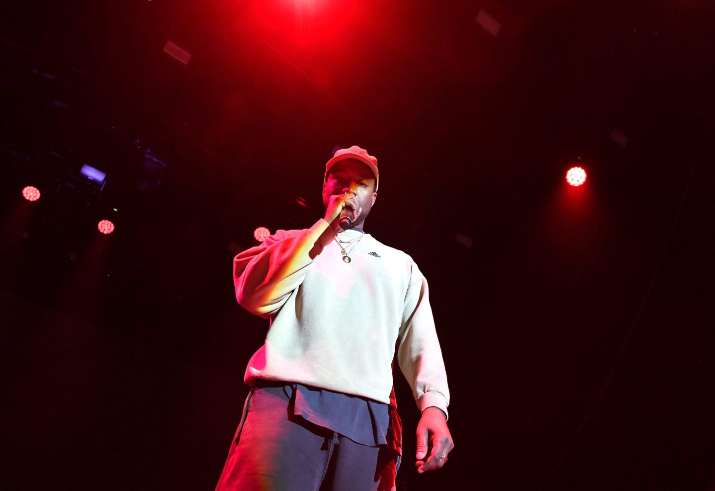 Kanye West appears onstage at an Adidas Creates 747 Warehouse event wearing an Adidas sweatshirt.
